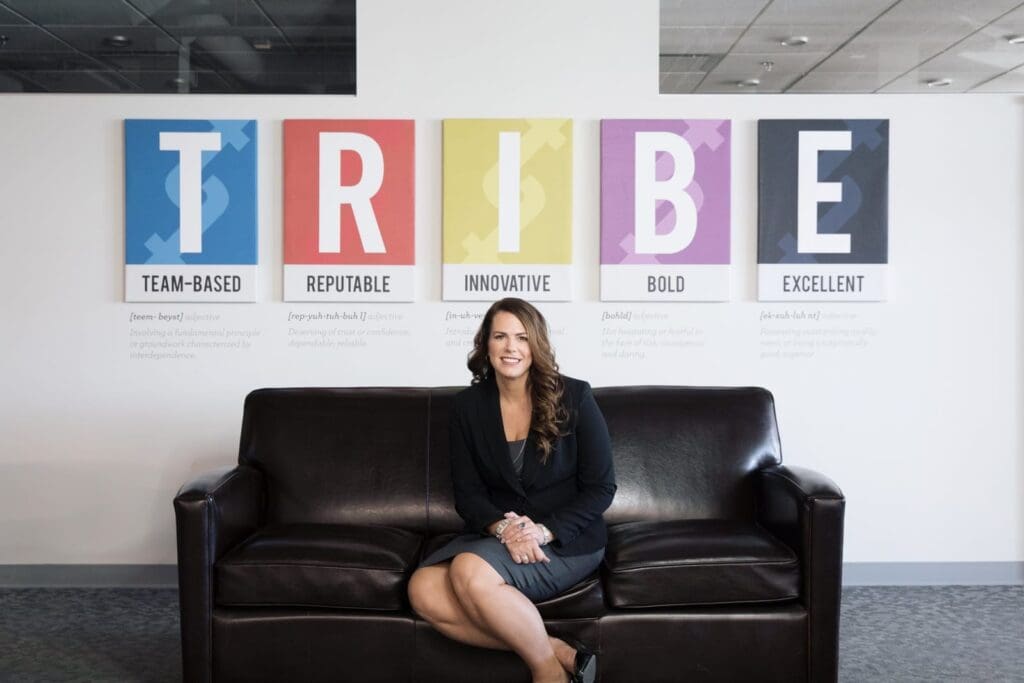 Renee Merrifield, Troika founder and CEO, in front of the TRIBE values wall at Troika's Kelowna office.